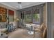 Charming sunroom with wood paneled walls, neutral carpet, and an abundance of windows at 619 E Pelham Ne Rd, Atlanta, GA 30324