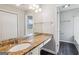 Bathroom with granite countertop and large mirror reflecting the natural light at 909 Chapman Cir, Stone Mountain, GA 30088