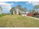 Two-story home with two-car garage and mature landscaping in neighborhood viewed from the front at 909 Chapman Cir, Stone Mountain, GA 30088