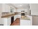 Well-lit kitchen features granite countertops, white cabinets, and black appliances at 909 Chapman Cir, Stone Mountain, GA 30088