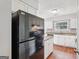 Kitchen with granite countertops, stainless steel appliances and white cabinetry at 909 Chapman Cir, Stone Mountain, GA 30088