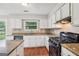 Kitchen featuring stainless steel appliances, granite counters and white cabinets at 909 Chapman Cir, Stone Mountain, GA 30088