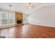 Spacious living room features a stone fireplace, laminate floors and large windows at 909 Chapman Cir, Stone Mountain, GA 30088