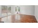 A living room featuring hardwood floors, neutral paint, and a sliding glass door at 909 Chapman Cir, Stone Mountain, GA 30088