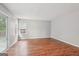 A living room featuring hardwood floors, neutral paint, and a sliding glass door at 909 Chapman Cir, Stone Mountain, GA 30088