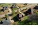 Aerial view shows the property within a residential neighborhood at 117 Berkeley Way, Hampton, GA 30228