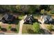 Aerial view showcases the home's roof, landscaping, driveway and surrounding neighborhood at 117 Berkeley Way, Hampton, GA 30228