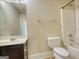 Standard bathroom features a combination tub and shower and a dark vanity with a white sink at 117 Berkeley Way, Hampton, GA 30228