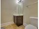 Cozy bathroom with compact vanity, a matching mirror, and a standard toilet at 117 Berkeley Way, Hampton, GA 30228
