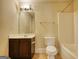 Bathroom with a combination tub and shower and a vanity with a white sink at 117 Berkeley Way, Hampton, GA 30228