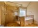 Spacious bathroom with a glass shower and a soaking tub, complete with neutral tiling and modern fixtures at 117 Berkeley Way, Hampton, GA 30228