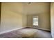 Bright bedroom with plush carpeting and natural light coming in from the window at 117 Berkeley Way, Hampton, GA 30228