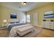 Cozy bedroom with a well-made bed, bench, lamps, rug, and a window to let light in at 117 Berkeley Way, Hampton, GA 30228