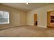 Comfortable bedroom with neutral carpet, two windows and access to an ensuite bathroom at 117 Berkeley Way, Hampton, GA 30228