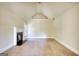Bedroom featuring a fireplace, neutral carpet, and a window offering natural light and a cozy atmosphere at 117 Berkeley Way, Hampton, GA 30228