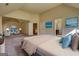 Large bedroom with sitting area, ensuite, king bed, rug, lamps, blue and cream decor at 117 Berkeley Way, Hampton, GA 30228