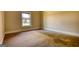 Cozy bedroom with plush carpeting and a window offering views of the surrounding neighborhood at 117 Berkeley Way, Hampton, GA 30228