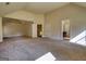 A spacious room with carpet, multiple doors, and natural light coming through the windows at 117 Berkeley Way, Hampton, GA 30228