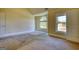 Bright bedroom with large windows, neutral walls, and plush carpeting at 117 Berkeley Way, Hampton, GA 30228