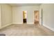 Comfortable bedroom with neutral carpet and doorways leading to other rooms at 117 Berkeley Way, Hampton, GA 30228