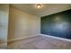 Neutral-toned bedroom features an accent wall and plush carpeting at 117 Berkeley Way, Hampton, GA 30228