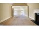 A spacious room with carpet, fireplace, and natural light coming through the windows at 117 Berkeley Way, Hampton, GA 30228
