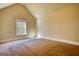 Cozy bedroom with plush carpeting and a window offering views of the surrounding neighborhood at 117 Berkeley Way, Hampton, GA 30228
