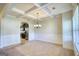Elegant dining room with coffered ceilings, wainscoting, and an arched doorway to the kitchen at 117 Berkeley Way, Hampton, GA 30228
