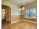 Cozy dining room featuring neutral tile flooring, a window, and access to other living spaces at 117 Berkeley Way, Hampton, GA 30228