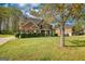 Front elevation of a two-story brick home with mature landscaping and ample front yard space at 117 Berkeley Way, Hampton, GA 30228