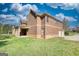 Exterior of brick home highlighting the lush green lawn and covered porch at 117 Berkeley Way, Hampton, GA 30228