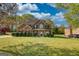 Charming two-story brick home with a well-manicured lawn and lush green landscaping at 117 Berkeley Way, Hampton, GA 30228