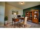 Comfortable home office with dark wood furniture, a bookshelf, and a decorative rug at 117 Berkeley Way, Hampton, GA 30228