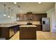 Modern kitchen with granite countertops, stainless steel appliances, and a central island at 117 Berkeley Way, Hampton, GA 30228