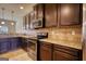Spacious kitchen featuring stainless steel appliances, granite countertops, and dark cabinetry at 117 Berkeley Way, Hampton, GA 30228