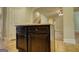 Kitchen island with dark brown cabinets and granite countertop, offering additional storage at 117 Berkeley Way, Hampton, GA 30228