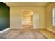 Open-concept living room featuring archways to dining room at 117 Berkeley Way, Hampton, GA 30228
