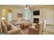 Bright living room featuring a fireplace, ceiling fan, neutral walls, and comfortable seating arrangement at 117 Berkeley Way, Hampton, GA 30228