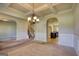 Open-concept living space with views to dining area, staircase, and kitchen at 117 Berkeley Way, Hampton, GA 30228