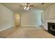 Spacious living room with carpet, fireplace, and ceiling fan, perfect for gatherings at 117 Berkeley Way, Hampton, GA 30228