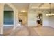 Spacious living room with arched doorways and view of staircase and modern kitchen at 117 Berkeley Way, Hampton, GA 30228