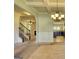 Open-concept living space showcasing staircase, fireplace, and a modern kitchen at 117 Berkeley Way, Hampton, GA 30228