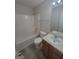 Bathroom featuring a soaking tub with shower, wood tone vanity with light countertop, and neutral colors at 1354 Persimmon Ct, Lithonia, GA 30058