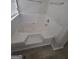 Close up of large soaking tub with tile surround and wood look floors at 1354 Persimmon Ct, Lithonia, GA 30058