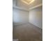 Bedroom featuring neutral paint, plush carpeting, and a unique tray ceiling at 1354 Persimmon Ct, Lithonia, GA 30058