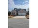 Charming brick home with a two-car garage and a well-maintained front lawn on a sunny day at 1354 Persimmon Ct, Lithonia, GA 30058