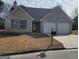 Charming brick home with a well-maintained yard and attached two-car garage at 1354 Persimmon Ct, Lithonia, GA 30058