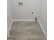 Laundry room with wood look vinyl flooring and utility hookups ready for a new washer and dryer at 1354 Persimmon Ct, Lithonia, GA 30058