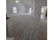 Spacious living room featuring plush carpeting, a ceiling fan, and natural light at 1354 Persimmon Ct, Lithonia, GA 30058