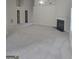 Vast living area with plush carpeting, a fireplace, and multiple doorways at 1354 Persimmon Ct, Lithonia, GA 30058